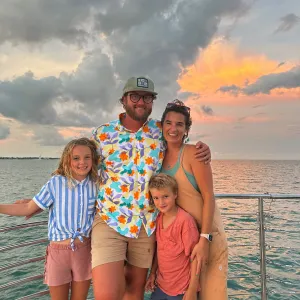 a group of people standing next to a body of water