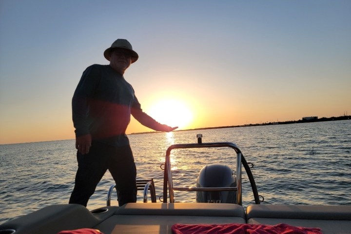 a man standing next to a body of water