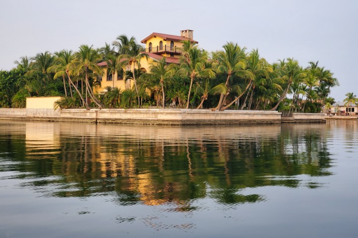 a small pond in front of a body of water