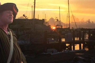 a man standing in front of a boat