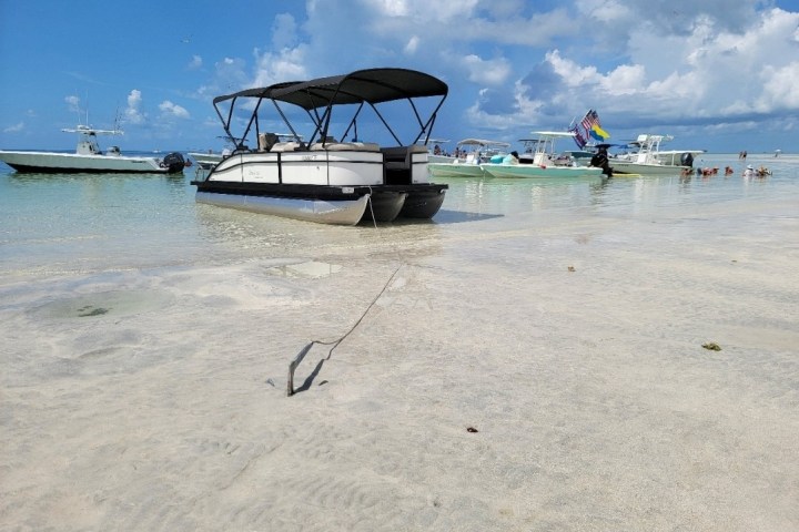 a boat sitting on top of a sandy beach